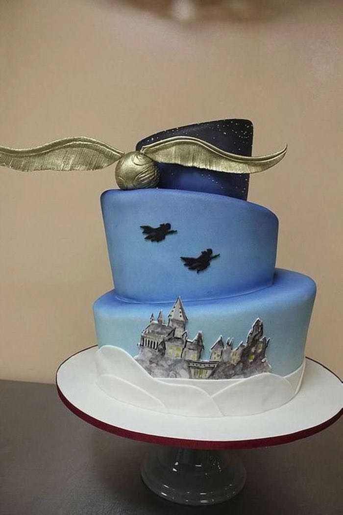 three tier cake, made with blue fondant, diy harry potter cake, golden snitch on the side, hogwarts drawn on bottom tier