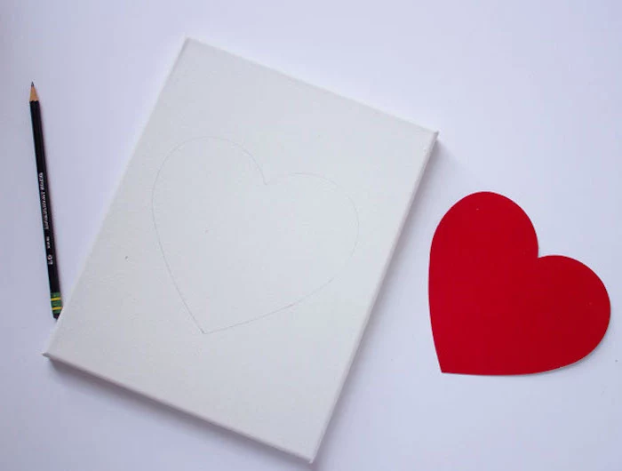 white canvas, red heart shape traced on it with pencil, placed on white surface, step by step diy tutorial, valentine decorations