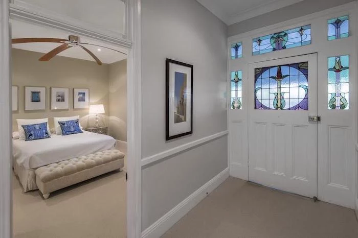 hallway and bedroom with white walls, white door decorated with stained glass, custom stained glass