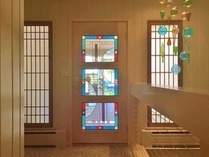 hallway with white walls, front door with colored glass, two windows on both sides, custom stained glass, stained glass chandelier