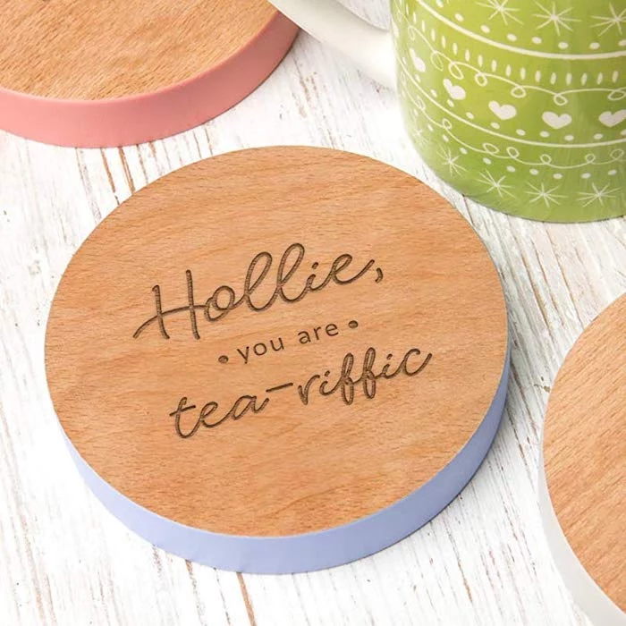 personalised wooden coasters, hollie you are tea riffic, valentine gifts for wife, placed on white wooden surface