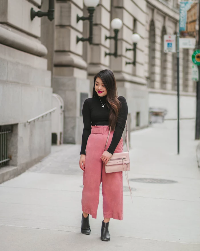 woman wearing black polo blouse, pink wide pants, black leather boots and pink bag, cute valentines day outfits