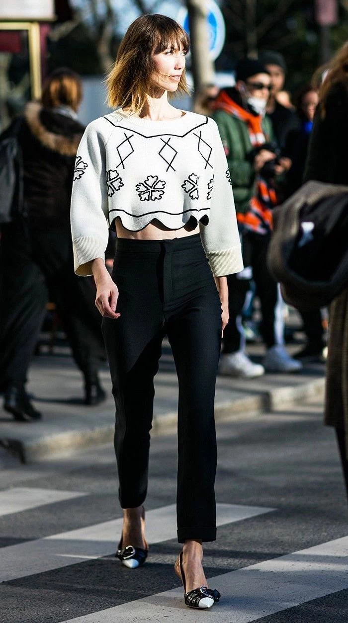 woman walking down the street, wearing white crop top, black pants, what to wear on valentine's day
