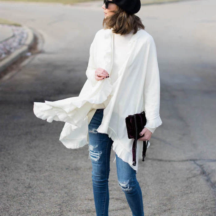 woman wearing jeans, what to wear on valentine's day, white blouse and kimono, holding black clutch bag