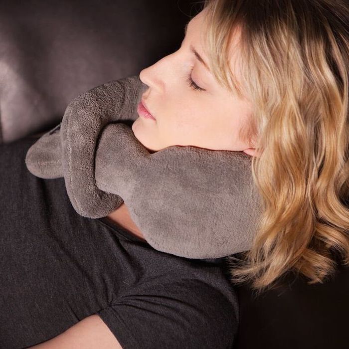 valentine's day gift ideas for her, woman with blonde hair, using a grey plush neck massager, wearing a black t shirt