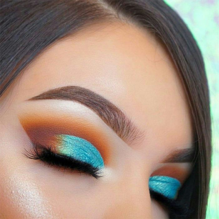 orange and turquoise eyeshadow colors, woman with brown hair, brown thick eyebrows, gold smokey eye