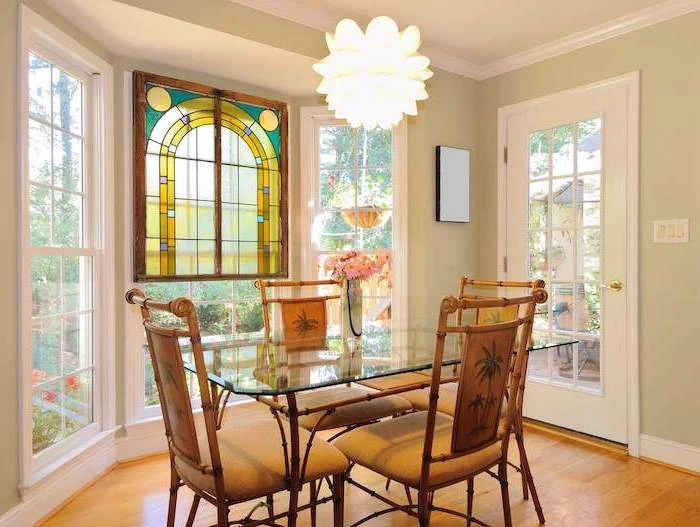custom stained glass windows, dining room with wooden floor, glass table and wooden chairs, tall windows and door
