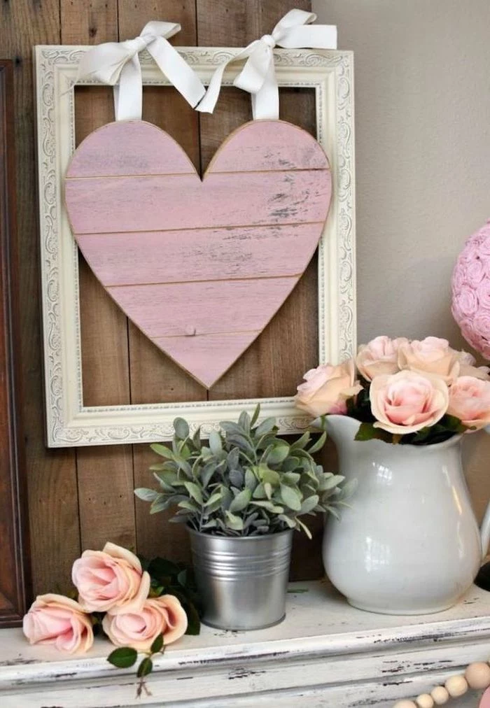 valentine day table decorations, vintage-wooden-frame, pink wooden heart in the middle, bouquets of pink roses