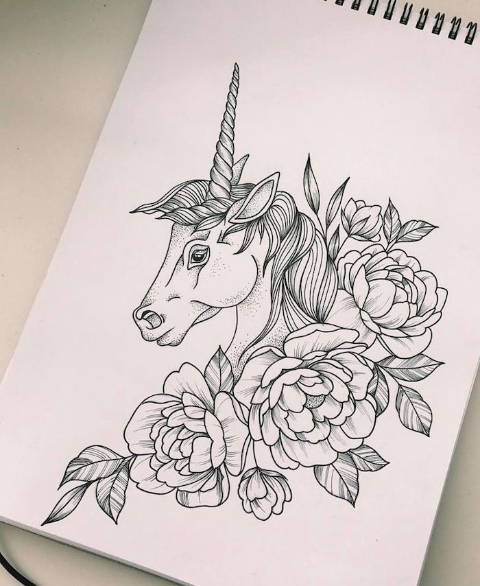 black and white pencil sketch of unicorn, surrounded by flowers, how to draw a unicorn, drawn on white background