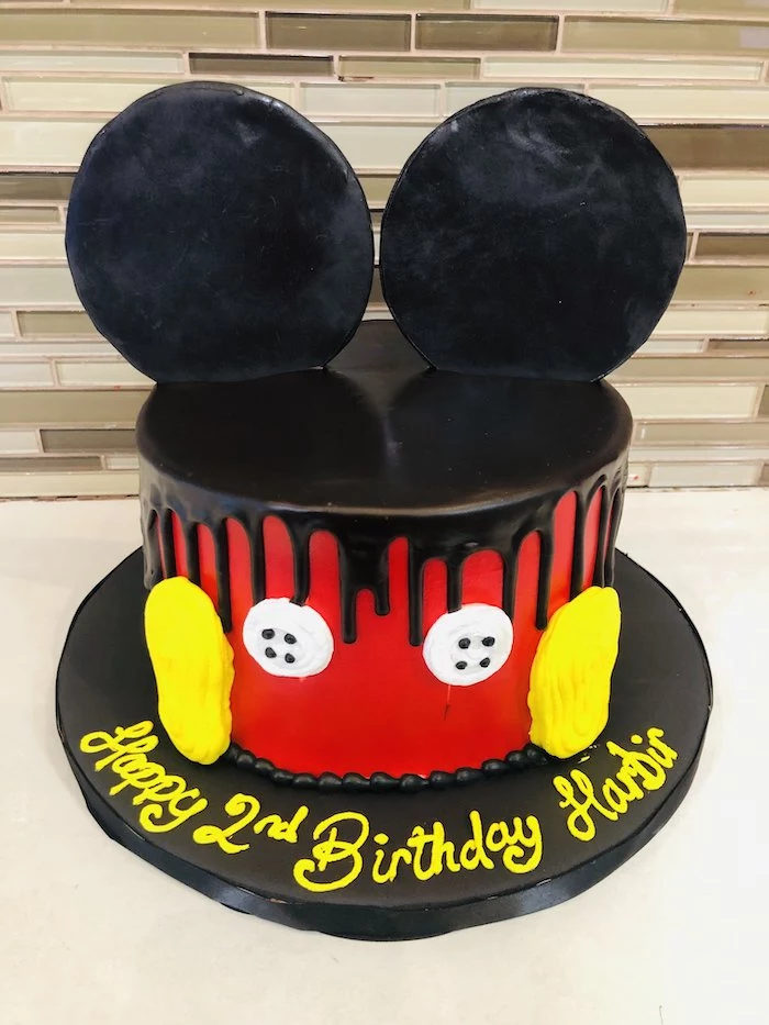 one tier cake, covered with red fondant, black fondant dripping from the sides, mickey mouse clubhouse cake