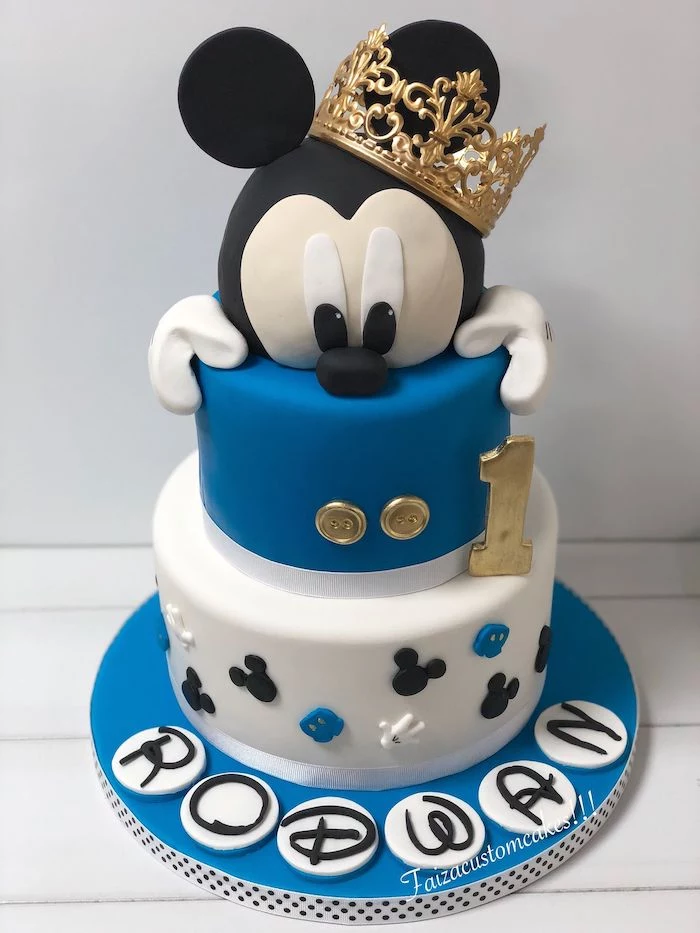 two tier cake, covered with blue and white fondant, mickey mouse birthday cake, gold crown decoration