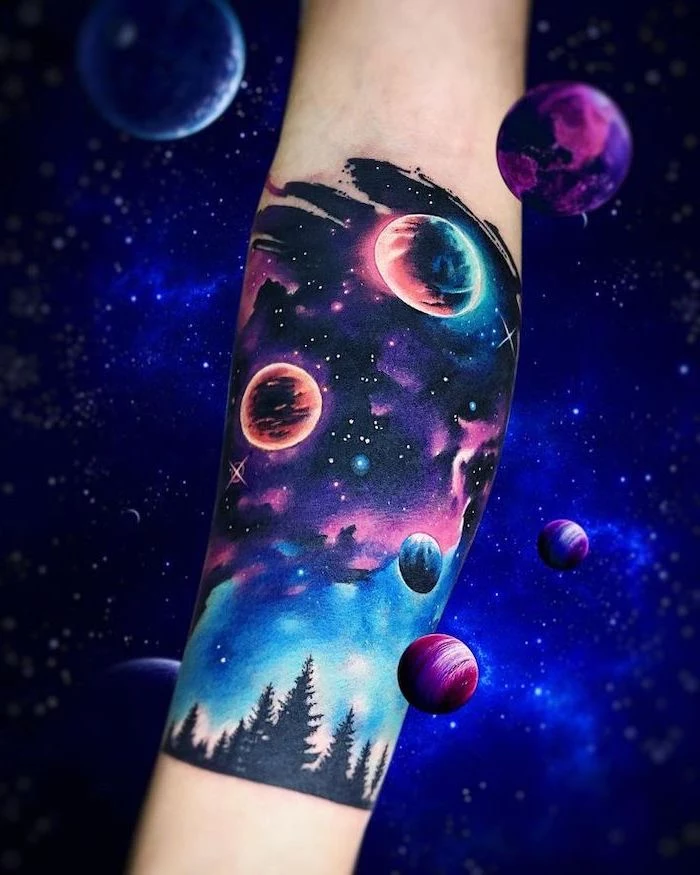 galaxy tattoo, forearm tattoo of galaxy in purple pink and blue colors, stars and planets above tall trees