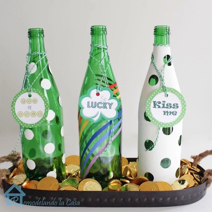 three green bottles, painted with different decorations, st patricks day decorations, out of luck, so lucky and kiss me tags