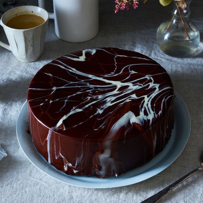 brown and white marble chocolate glaze on one tier cake, mirror glaze recipe, placed on white plate