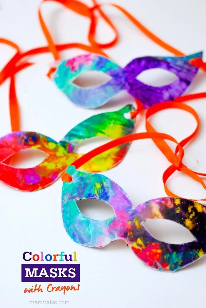 masquerade masks for men, step by step diy tutorial, colorful masks with crayons, tied with red ribbons
