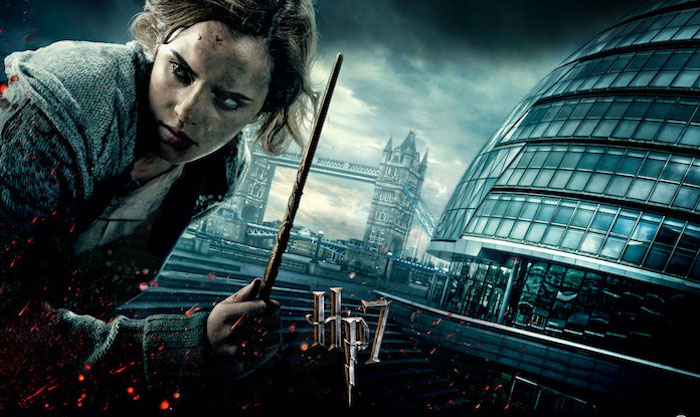 emma watson as hermione granger, holding a wand, deathly hallows poster, harry potter desktop background, tower bridge in the background