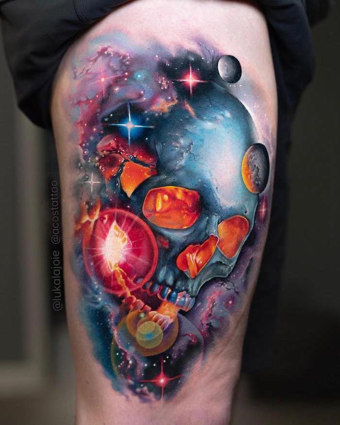 skull in space with planets and stars around it, outer space tattoo, watercolor thigh tattoo