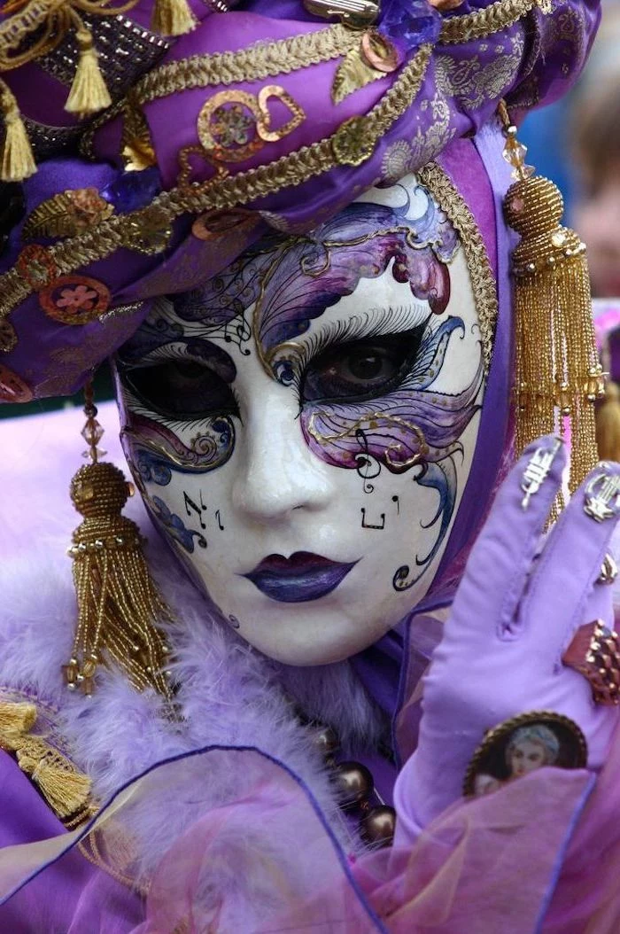 woman dressed in purple and gold costume, masquerade masks for men, mask with purple decorations painted on it