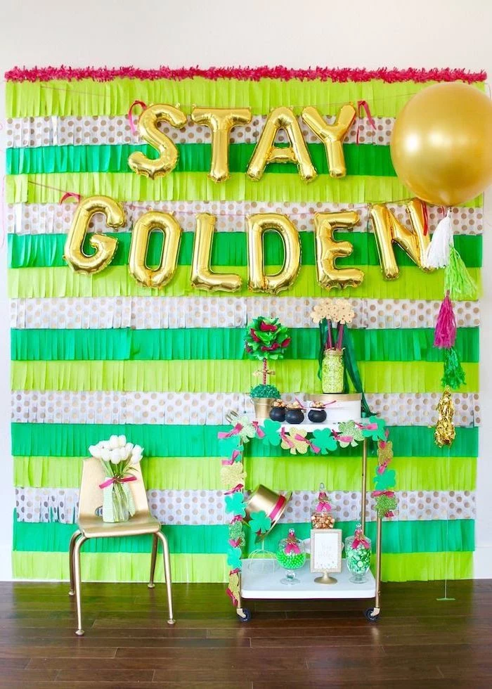 stay golden balloons, hanging on wall with green fringe paper garlands, happy st patrick's day, cocktail bar