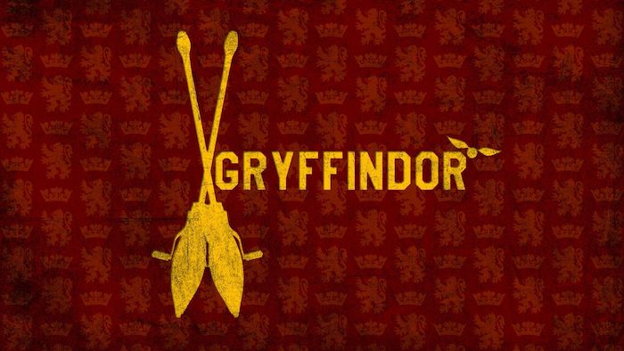harry potter phone wallpaper, gryffindor written in yellow, over a red background, two brooms on the side