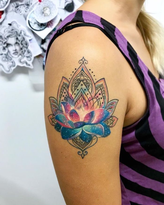 mandala lotus flower shoulder tattoo, space tattoo ideas, pink and blue galaxy with stars, woman wearing black and purple top