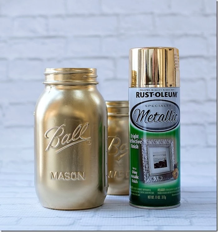 step by step diy tutorial, st patricks day crafts, mason jar painted in gold, spray can next to it, placed on white surface