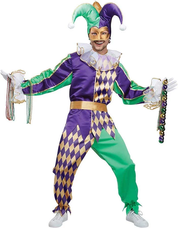 man wearing a gold green and purple jester costume, masquerade ball masks, gold mask and jester hat, lots of bead necklaces