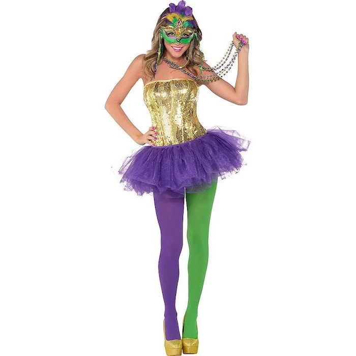 woman wearing purple green and gold costume, beads necklaces, masquerade party masks, green and gold purple mask