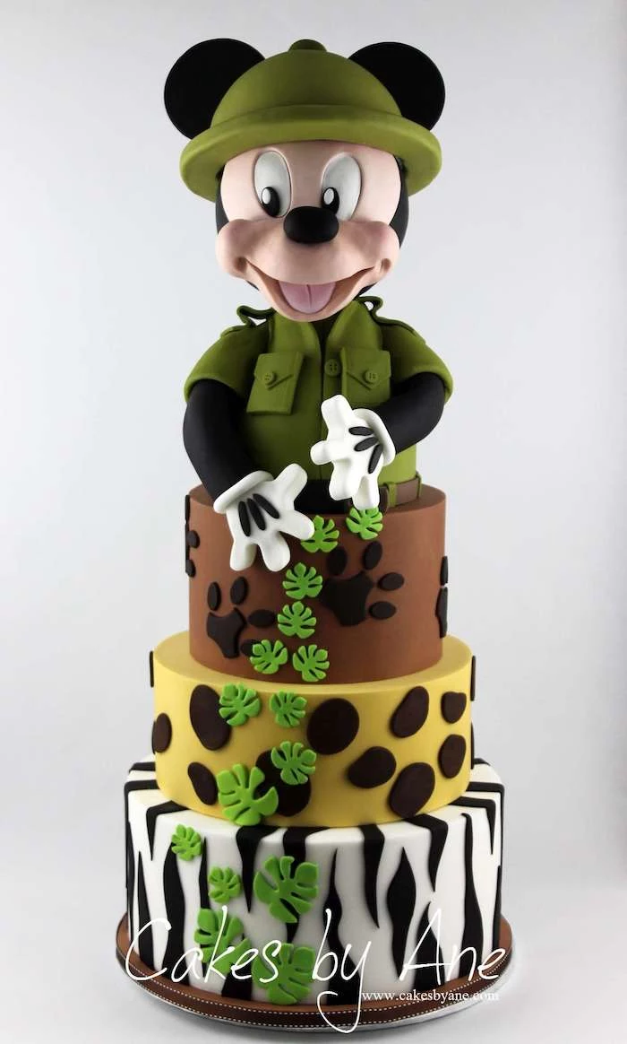 safari cake, mickey cake, four tier cake, covered with white and black, green brown and yellow fondant