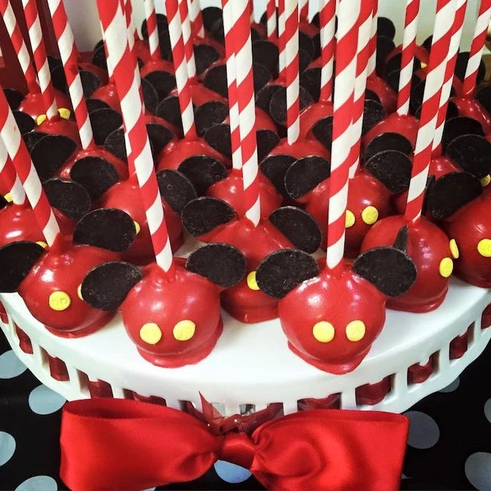 cake pops, covered with red chocolate, mickey mouse cakes 1st birthday, arranged on white cake stand