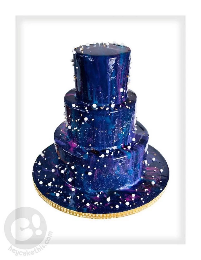 glaze icing for cake, three tier cake, covered with blue pink and purple glaze, white background, white sprinkles on it