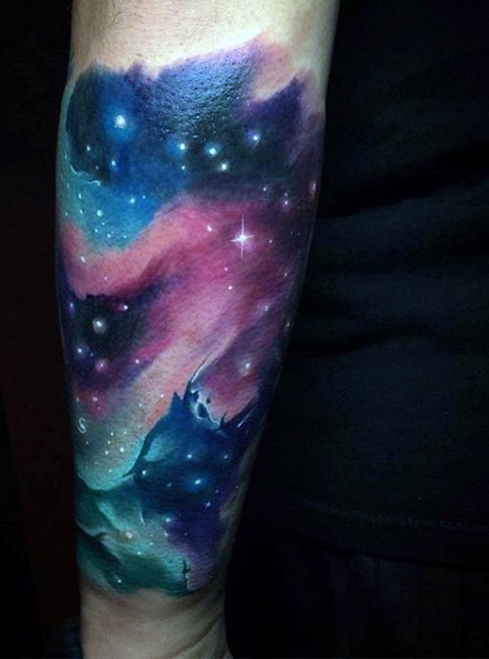 purple pink blue and turquoise colored galaxy, space themed tattoos, back of arm tattoo, black background