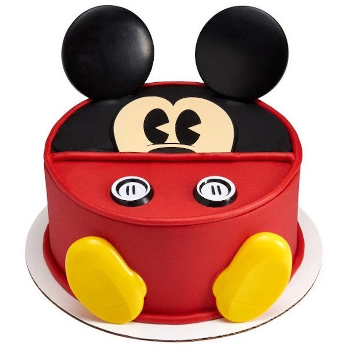 one tier cake, covered with red and black fondant, mickey mouse cake pops, placed on white cake tray