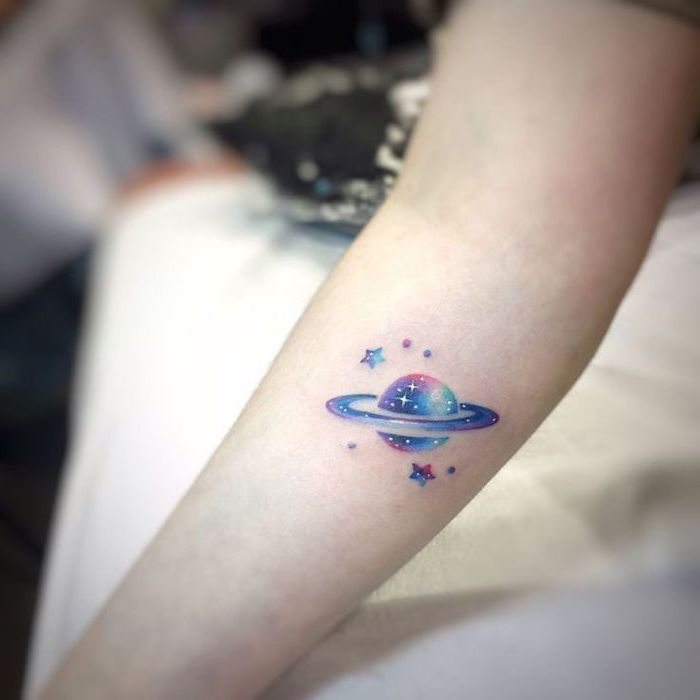 planet surrounded by stars, galaxy tattoo ideas, galaxy in pink purple and blue, forearm tattoo