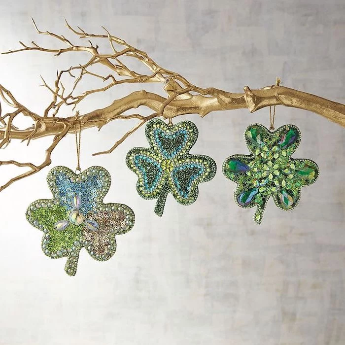 tree branch painted in gold, three shamrocks hanging on it, covered with rhinestones, st patrick's day wreath