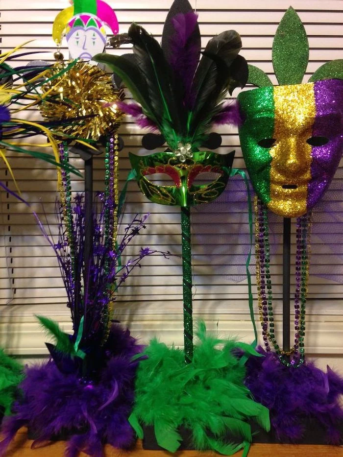 mens mardi gras masks, two different masks, decorated with green gold and purple glitter, purple and green feathers
