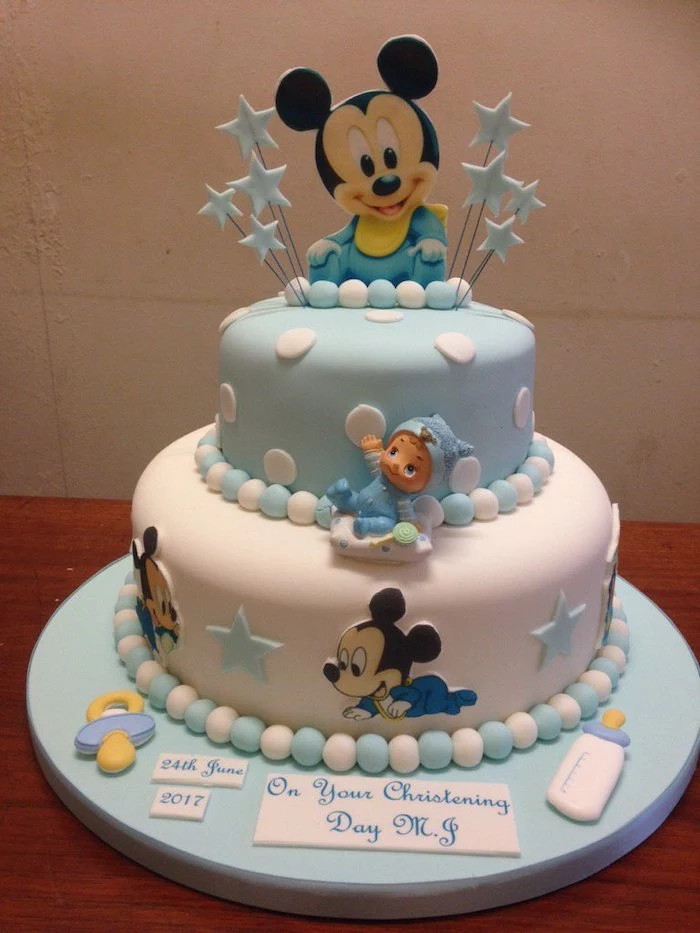 two tier cake for christening, covered with blue and white fondant, mickey mouse cake decorations, mickey cake topper