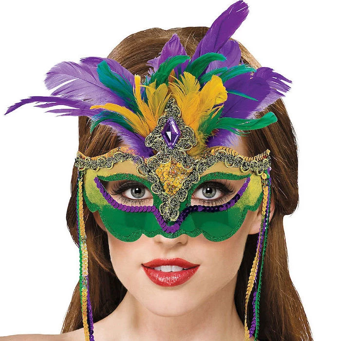 brunette woman with red lipstick, wearing a mask, mens mardi gras masks, decorated in purple green and gold sequins
