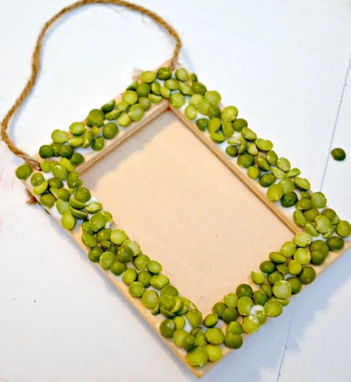 wooden frame covered with split peas, st patricks day decorations, placed on white surface