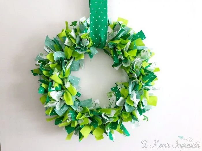wreath made with green and white ribbons, hanging on white wall, st patricks day games, hanged with green ribbon