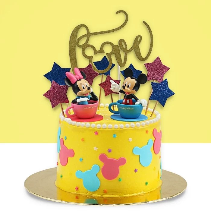 one tier cake, covered with yellow fondant, mickey mouse baby shower cake, mickey and minnie cake toppers