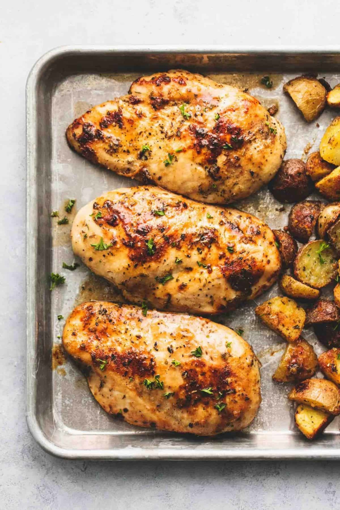 three chicken breasts, baked in a sheet pan, whats for dinner tonight, roasted potatoes next to them
