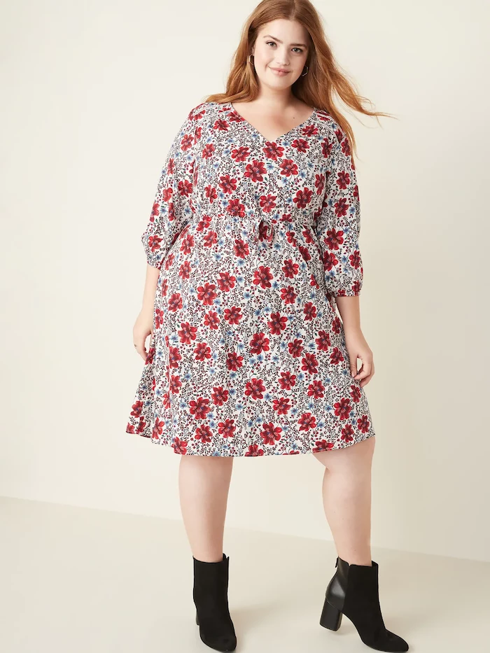 woman with red hair, wearing a white dress with red flowers print, easter dresses for women, black velvet boots