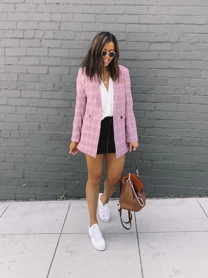 outfit ideas for school, brunette woman wearing black skirt and white top, pink plaid blazer, white sneakers