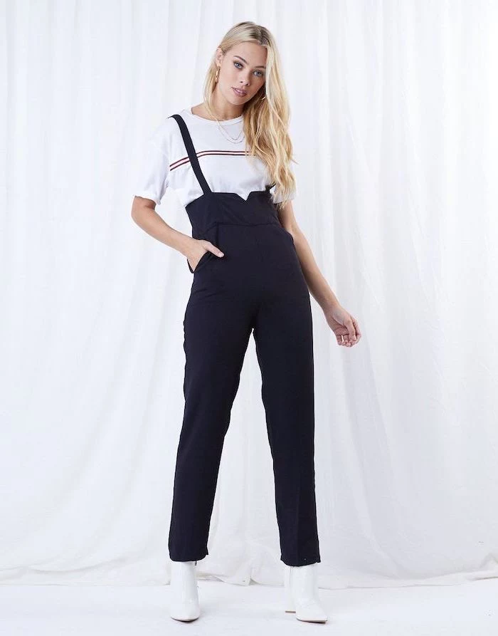 blonde woman wearing black overalls, white t shirt and leather boots, outfit ideas for school, white background
