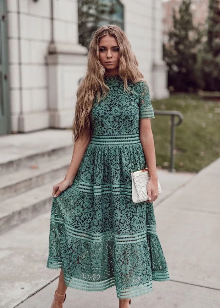 woman with long blonde wavy hair, wearing a green lace dress, easter dresses for girls, standing on sidewalk