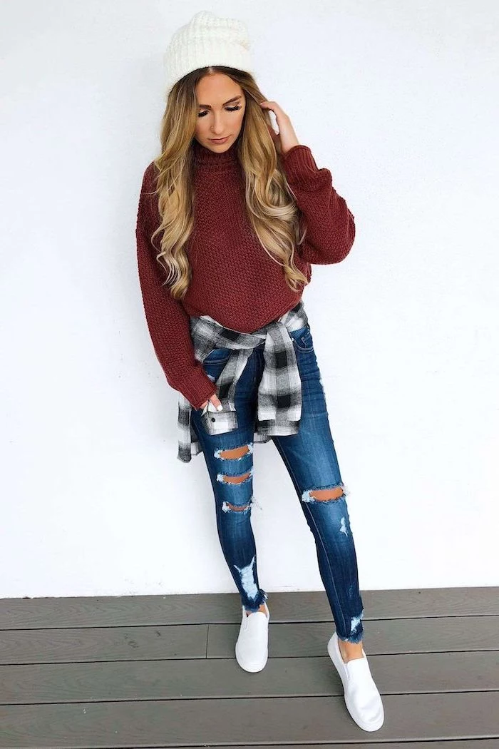 blonde woman wearing jeans, red sweater and plaid shirt around her waist, cute fall outfits, white beanie and sneakers
