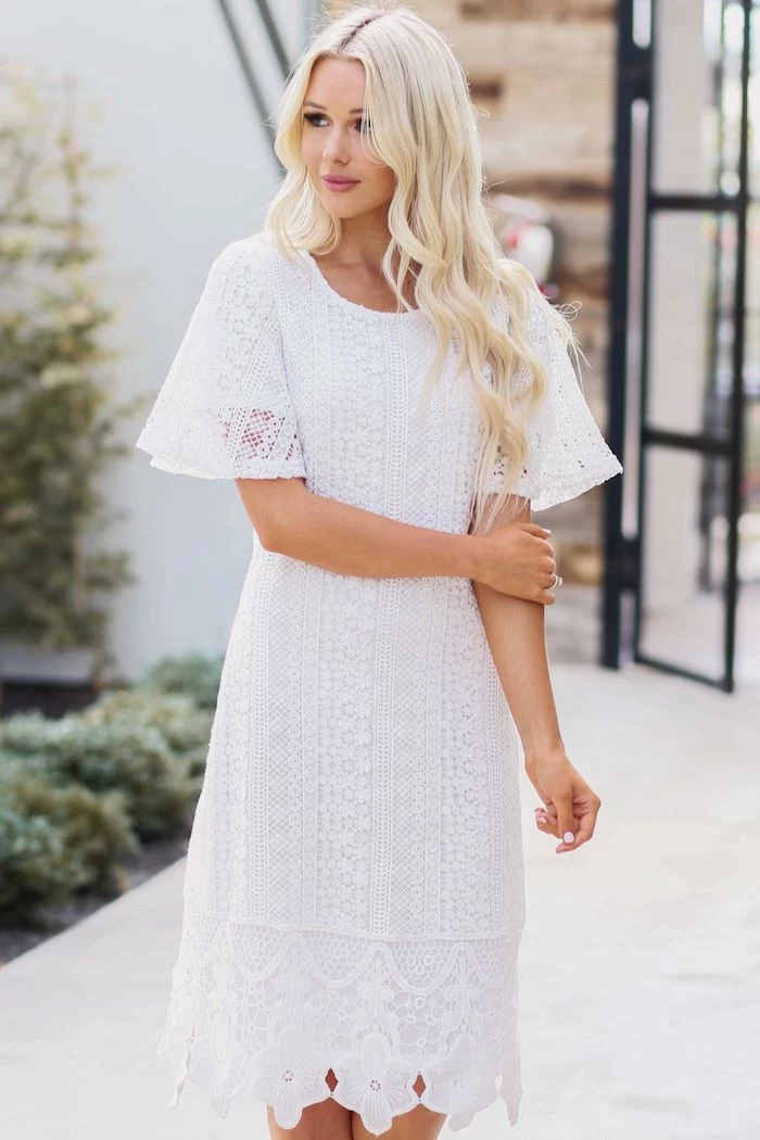 flowy dresses, woman with long blonde wavy hair, wearing white lace dress with short sleeves