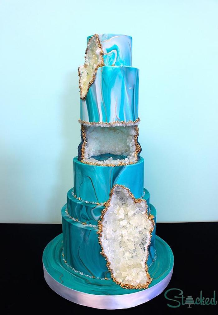 six tier cake, covered with blue and white fondant, geo cake, decorated with white rock candy