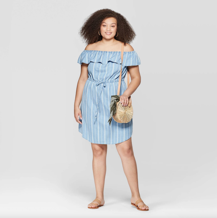 woman with brown curly hair, wearing blue dress with bare shoulders, nude sandals, flowy dresses